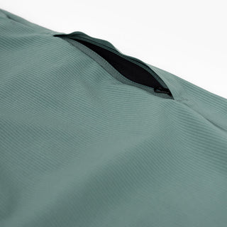 detail view of the zippered leg pocket of the ciele athletics CCPants unisex running pants from the Lifestyle Edition collection, in silver pine color
