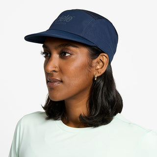 side view of the ciele athletics GOCap unisex running hat in deep space color, on a model