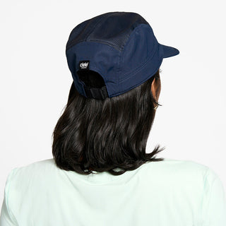 back view of the ciele athletics GOCap unisex running hat in deep space color, on a model
