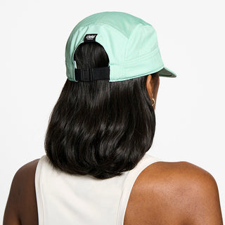 back view of the ciele athletics GOCap unisex running hat in dusty turquoise color, on a model