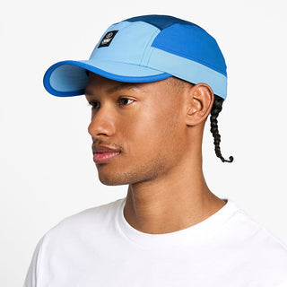 side view of the ciele athletics GOCap unisex running hat with a curved brim in dusty blue color, on a model