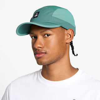 side view of the ciele athletics GOCap unisex running hat with a curved brim in silver pine color, on a model