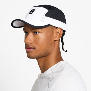 side view of the ciele athletics GOCap unisex running hat with a curved brim in trooper color, on a model