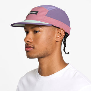 side view of the ciele athletics GOCap unisex running hat in deco rose color, on a model