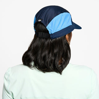 back view of the ciele athletics FTSCap unisex running hat with a curved brim in indigo color, on a model
