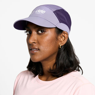 side view of the ciele athletics FTSCap unisex running hat with a curved brim in light grape color, on a model