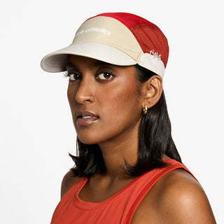 side view of the ciele athletics FTSCap unisex running hat in safari red color, on a model