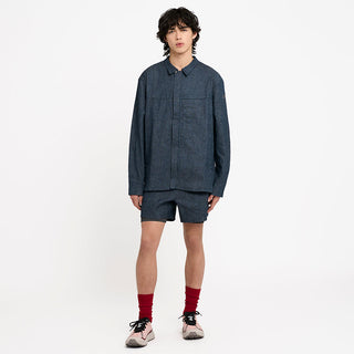 worn picture of the ciele athletics WRKShort unisex running and technical short from the Lifestyle Edition collection, in denim indigo color, on a model also wearing the CCJacket in Indigo Denim